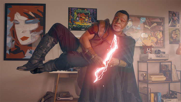 a middle aged black man in a superhero costume with lightning for a tie