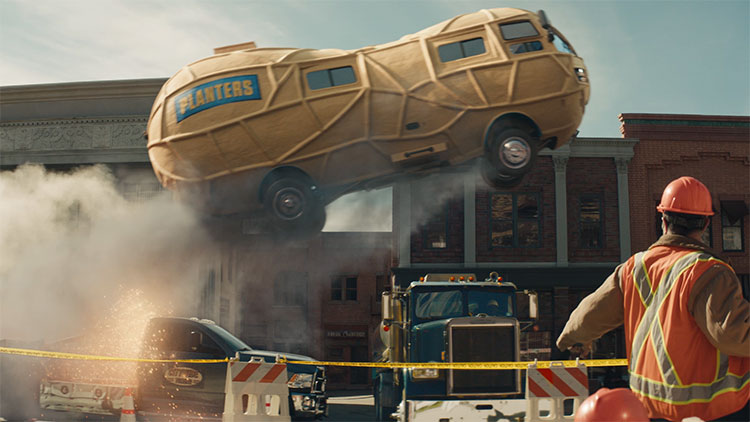 a peanut shaped vehicle jumping over an 18-wheeler truck