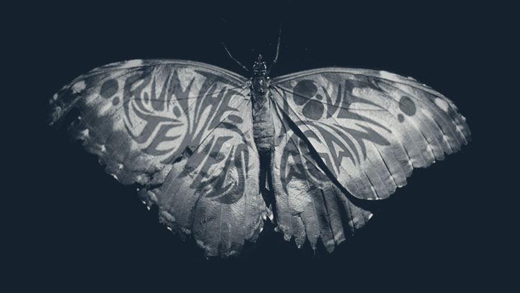 a blue and gold butterfly with Run the Jewels on one wing and Love Again on the other